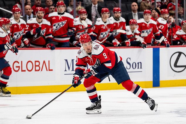 Washington Capitals right wing Ryan Leonard (9) skates with the puck during the first period of an NHL hockey game against New Jersey Devils, Saturday, Oct. 17, 2026, in Washington. (AP Photo/Nathan Howard)