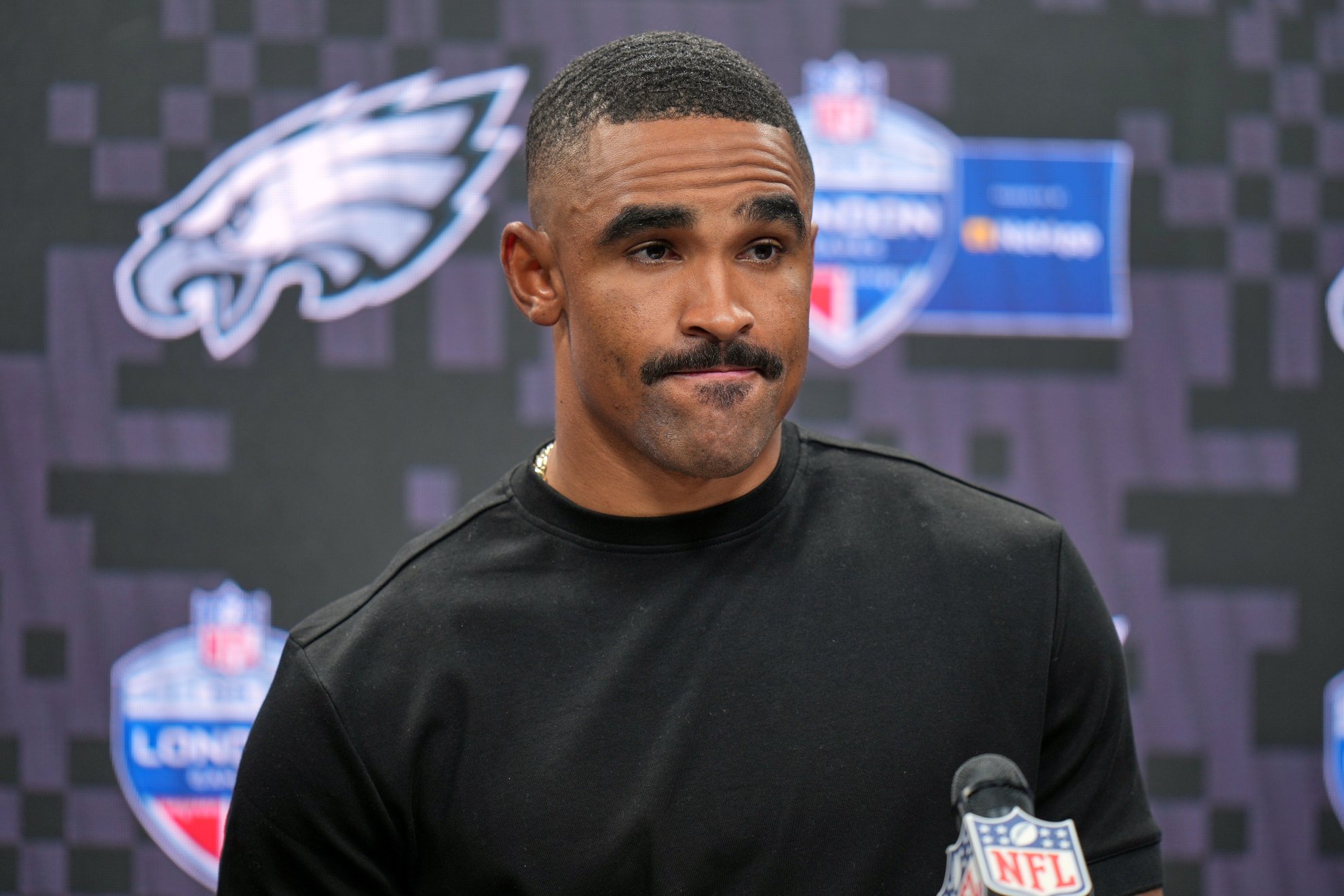 Philadelphia Eagles quarterback Jalen Hurts (1) attends a press conference after an NFL football game against Jacksonville Jaguars in London