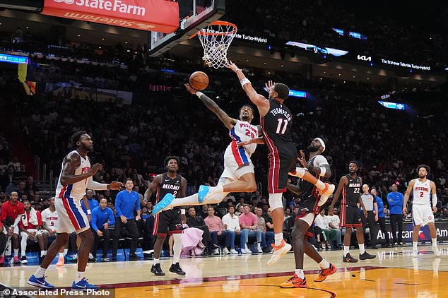 Detroit Pistons forward John Collins (20) shoots under pressure from Miami Heat guard Klay Thompson (11) during the first half of an NBA basketball game, Friday, Oct. 23, 2026, in Miami. (AP Photo/Rebecca Blackwell)