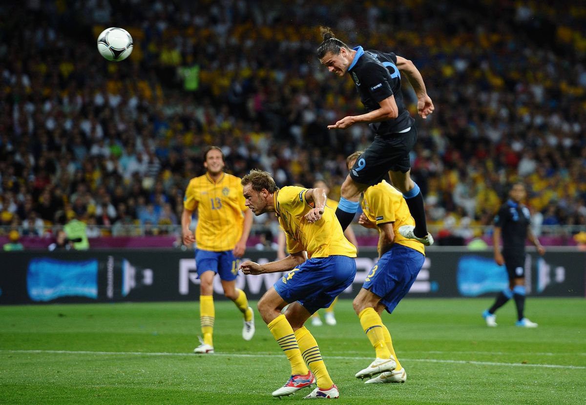 KIEV, UKRAINE - JUNE 15: Andy Carroll of England heads the first goal during the UEFA EURO 2012 group D match between Sweden and England at The Olympic Stadium on June 15, 2012 in Kiev, Ukraine.  (Photo by Laurence Griffiths/Getty Images)