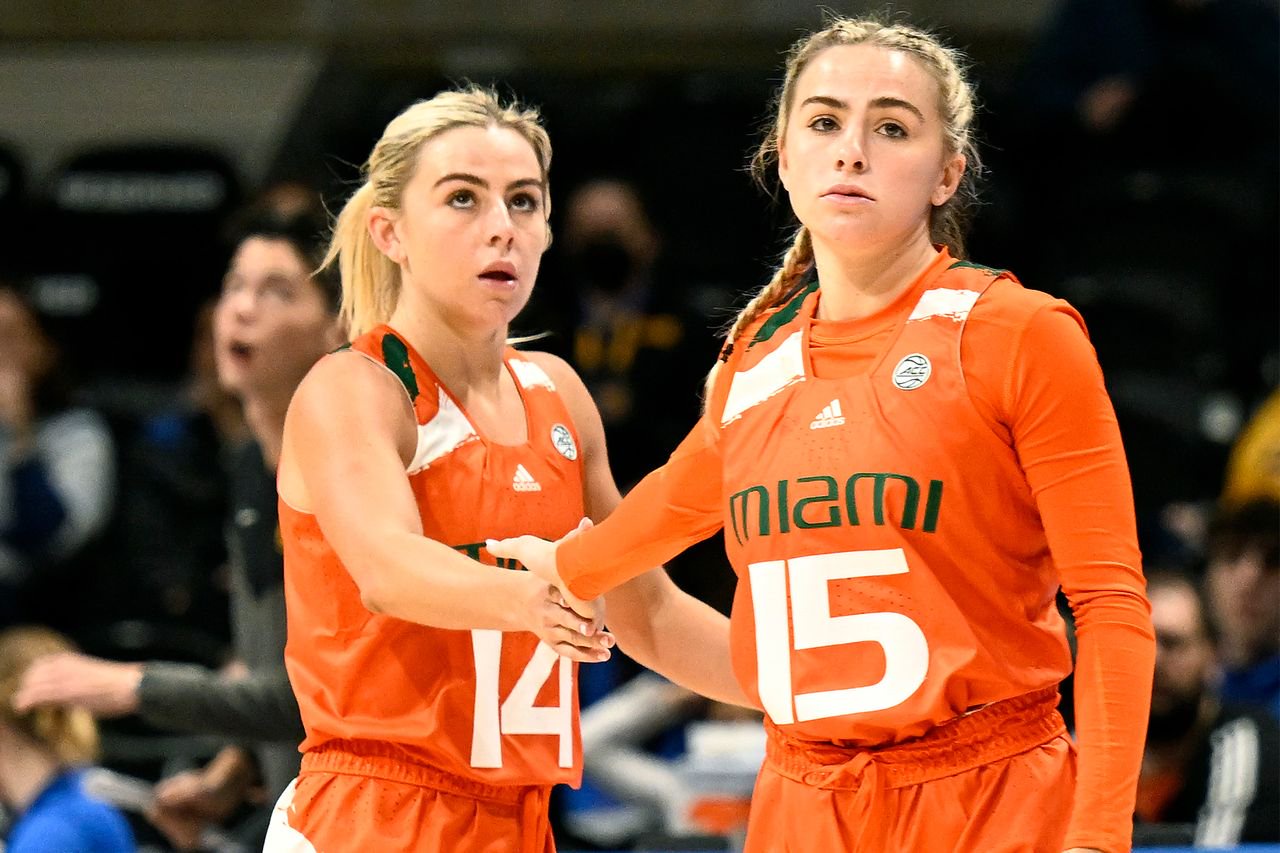 Haley Cavinder #14 and Hanna Cavinder #15 of the Miami Hurricanes celebrate during the game against the Pittsburgh Panthers at Petersen Events Center on Jan. 1, 2023 in Pittsburgh.Credit: G Fiume/Getty